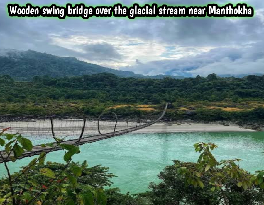 Wooden swing bridge over the glacial stream near Manthokha