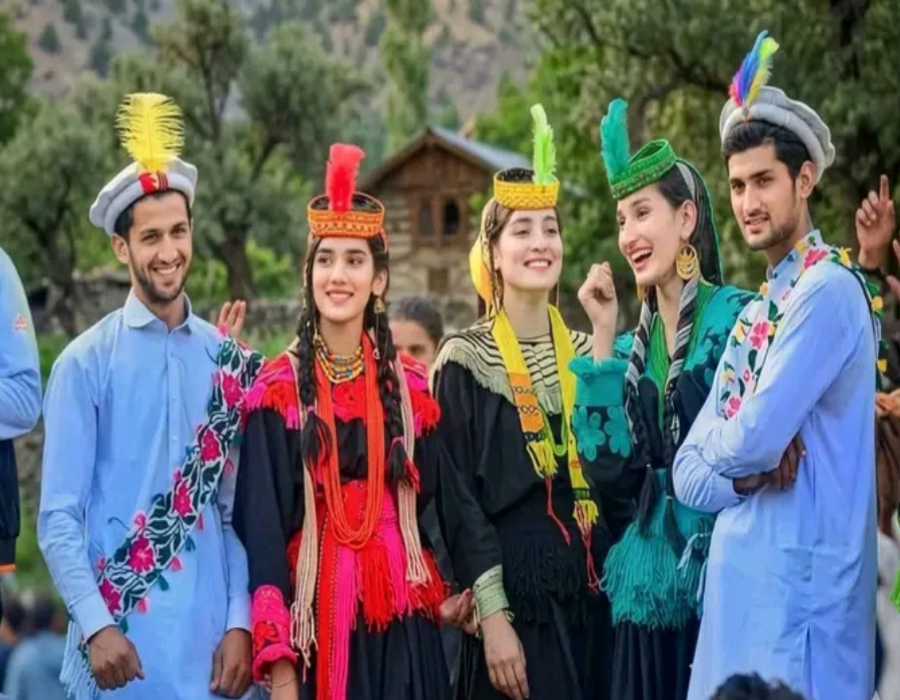 Kalash women wearing traditional black embroidered dresses with colorful beads and headpieces during Chilam Joshi Festival 2026