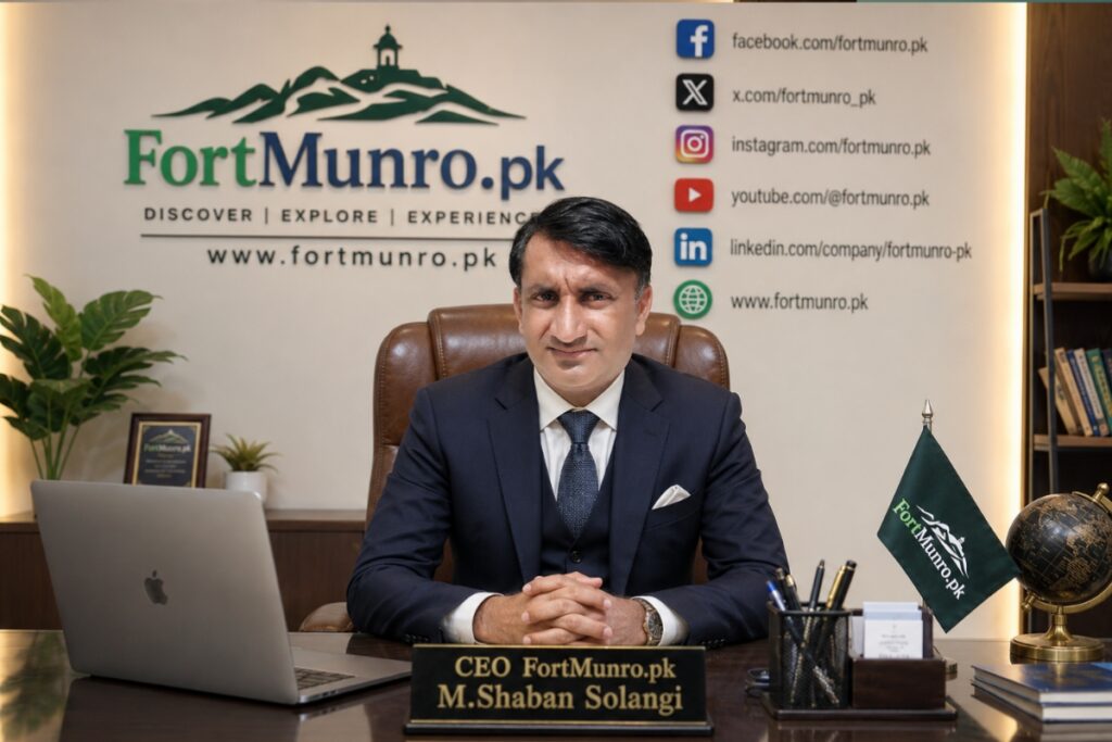 CEO of Fortmunro.pk, M. Shaban Solangi, sitting confidently in a modern corporate office wearing a formal suit and tie, with Fortmunro.pk branding, Pakistan flag, social media icons, and Quaid-e-Azam portrait displayed on the background wall.